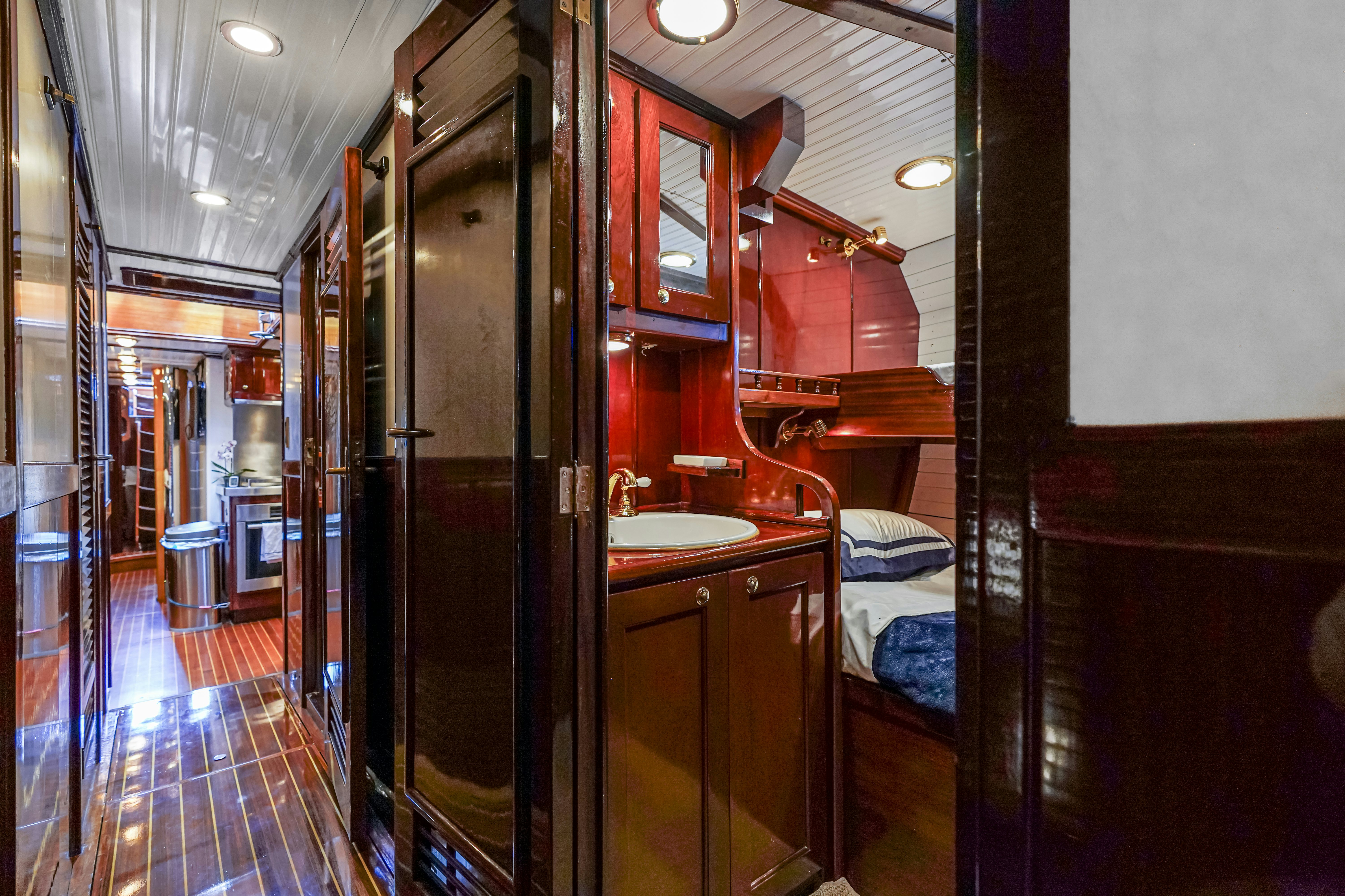 a bathroom with a sink and a bed aboard HERMITAGE Yacht for Sale