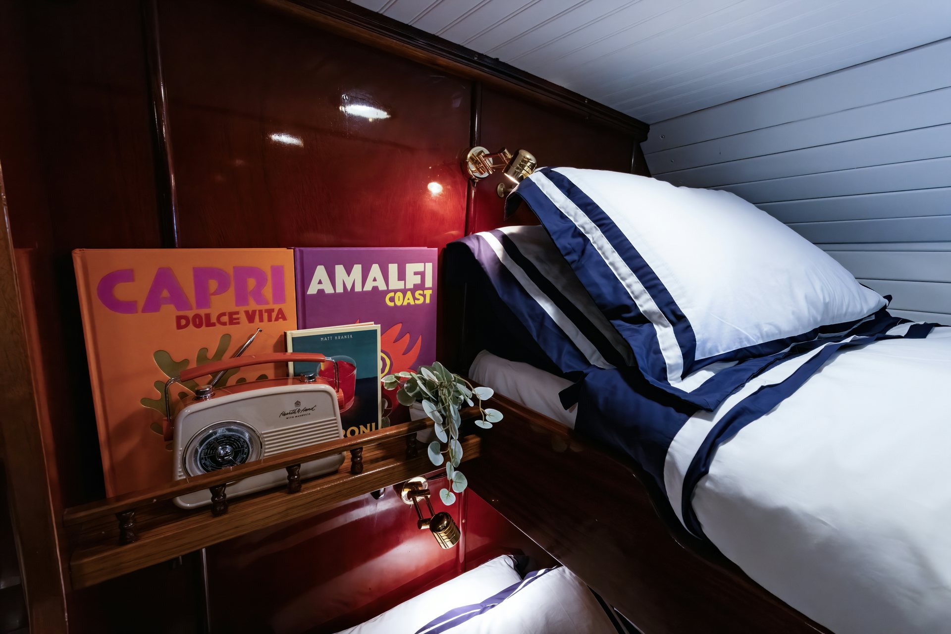 a bed with a blue and white striped blanket and a white car on it aboard HERMITAGE Yacht for Sale