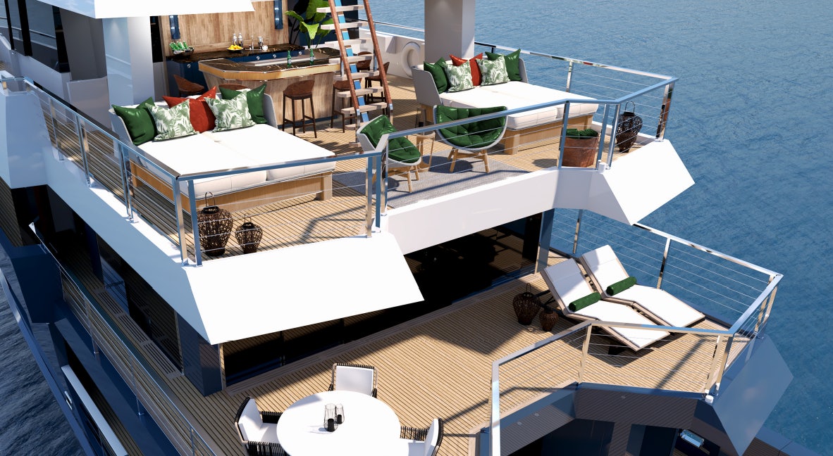 a room with a bed and a table and chairs aboard KING BENJI Yacht for Sale