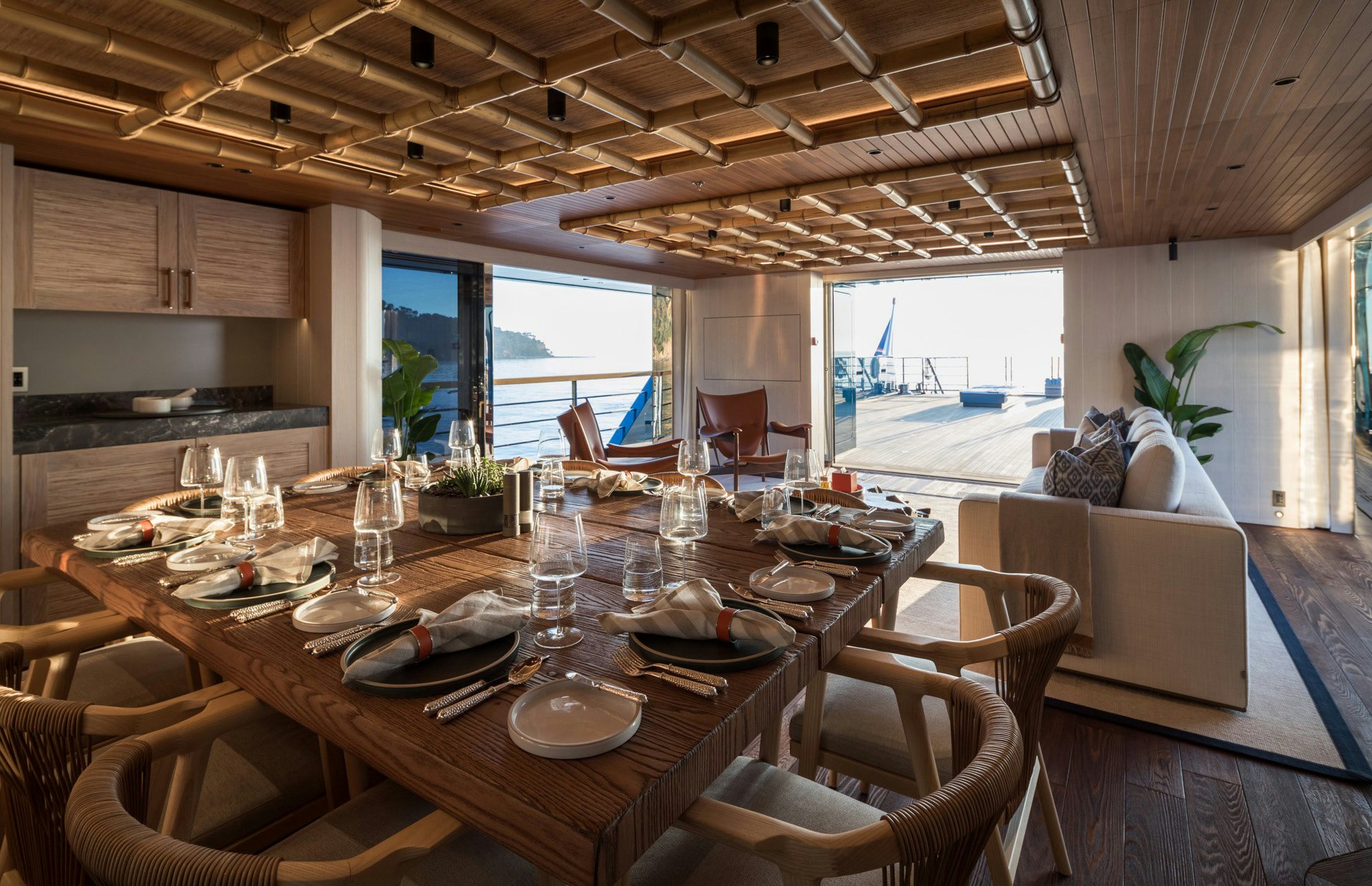 a dining table with chairs and a large window aboard KING BENJI Yacht for Sale