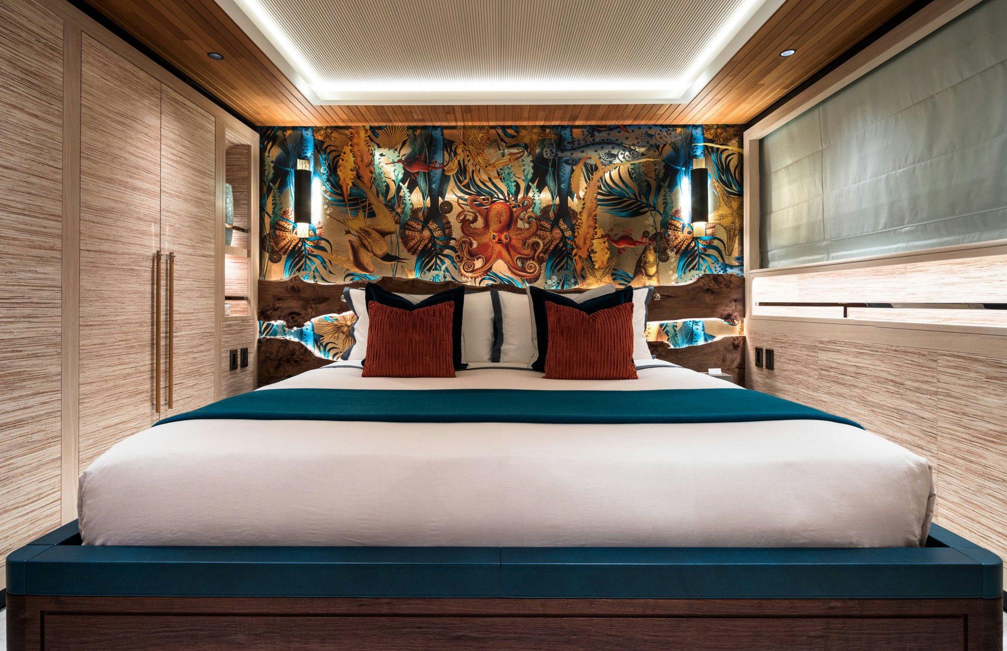 a bed with a blue sheet aboard KING BENJI Yacht for Sale