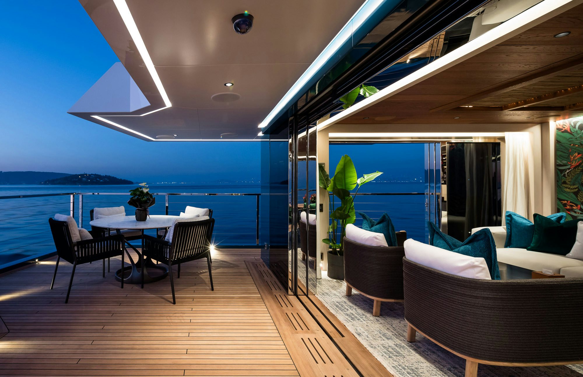 a room with a table chairs and a large window overlooking the ocean aboard KING BENJI Yacht for Sale