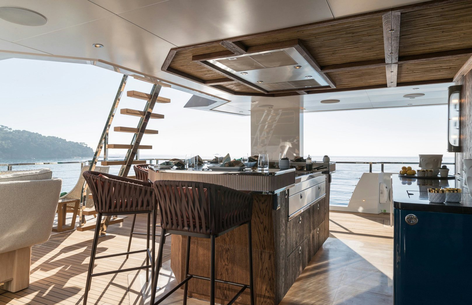 a kitchen with a bar and a table and chairs aboard KING BENJI Yacht for Sale