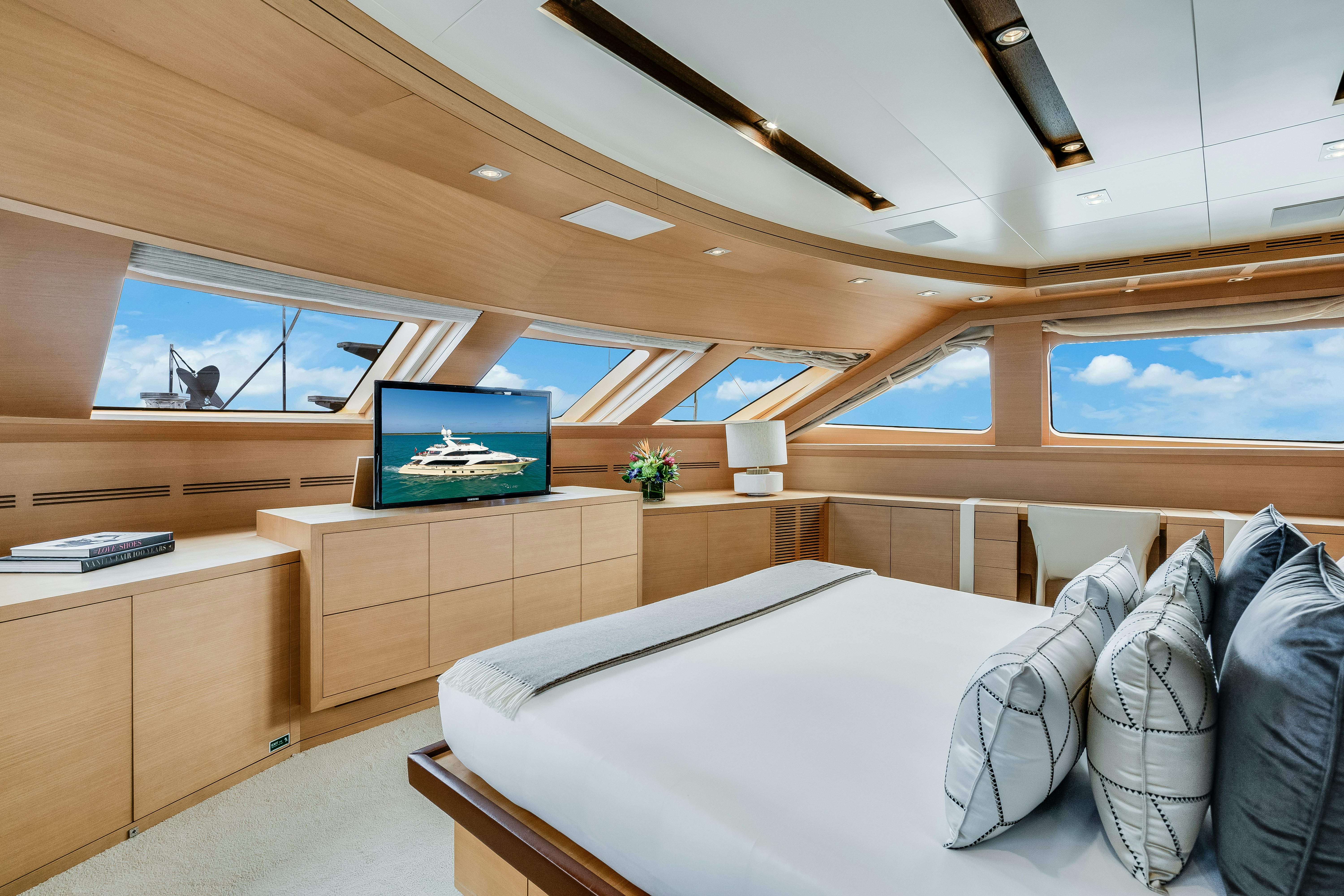 a room with a bed and a tv aboard LADY H Yacht for Charter