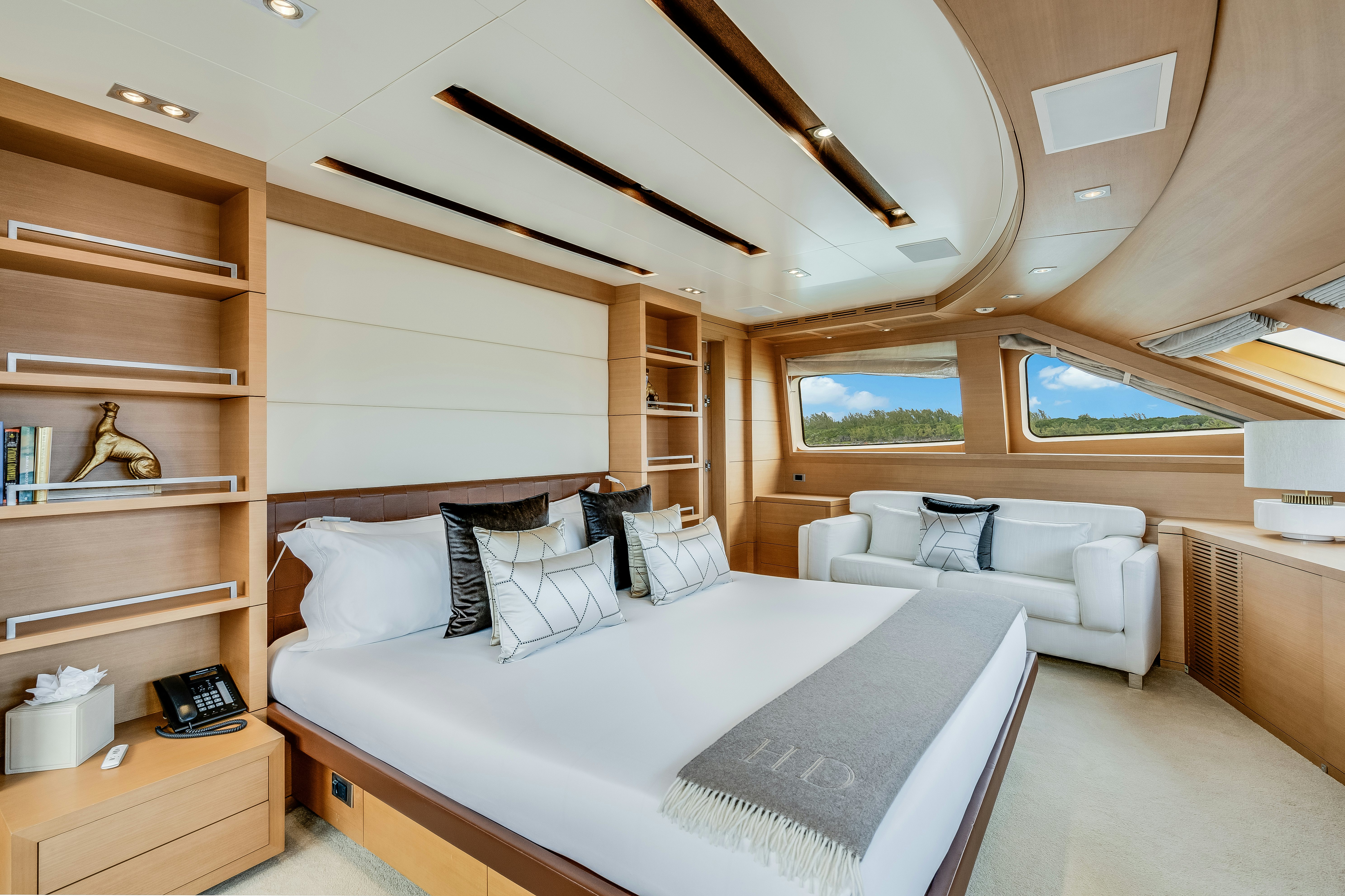 a bedroom with a bed and a couch aboard LADY H Yacht for Charter