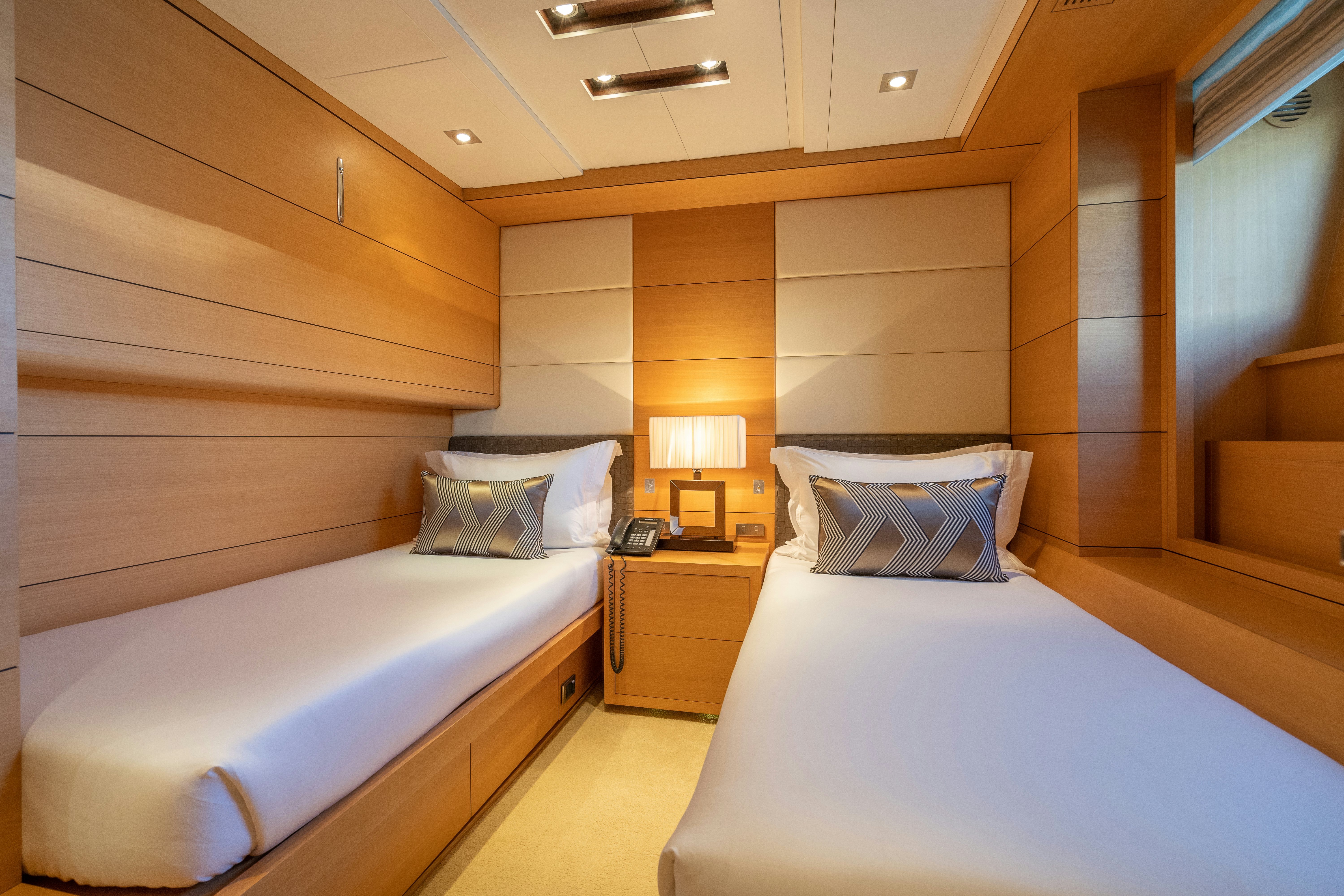 a couple of beds in a room aboard LADY H Yacht for Charter