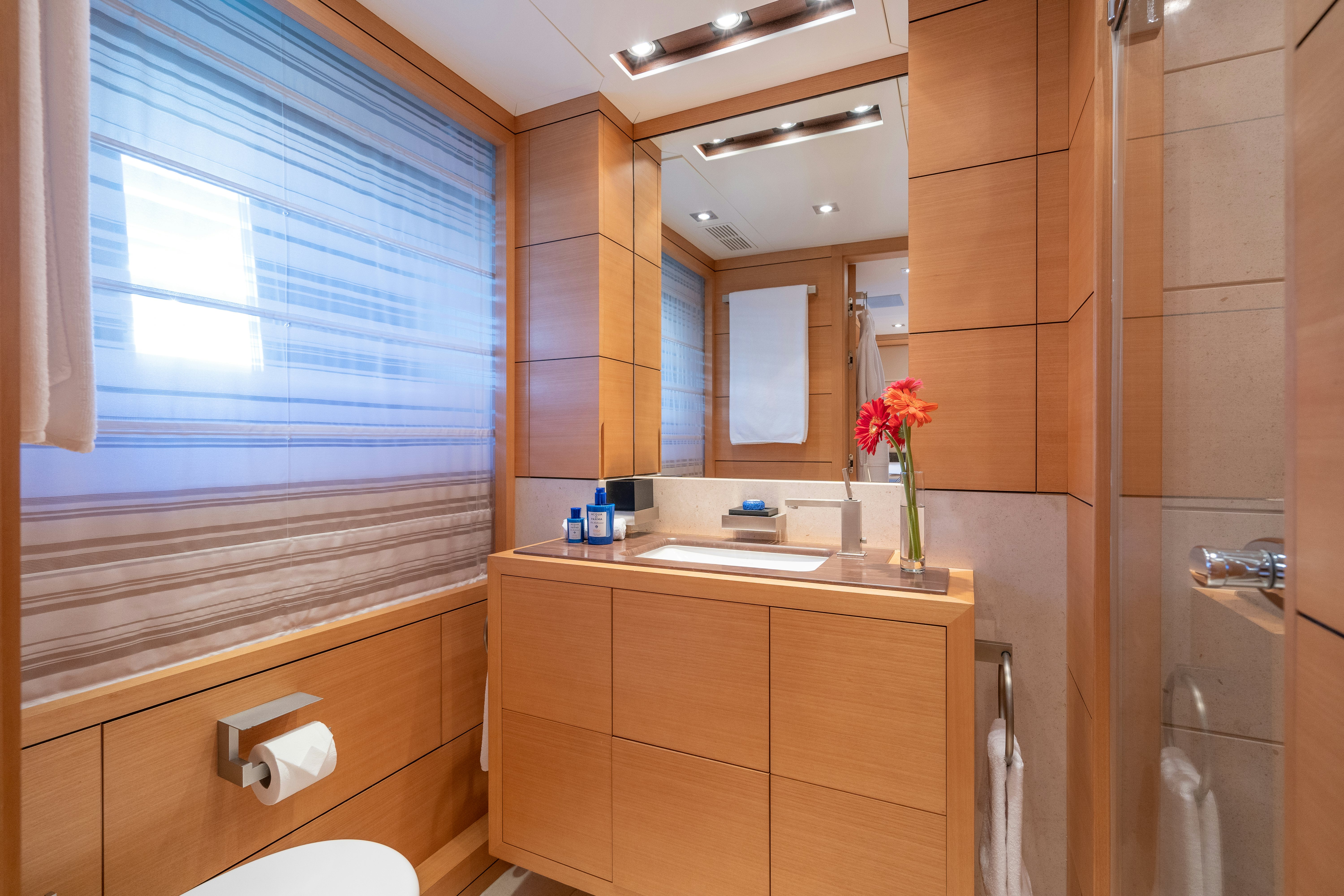 a bathroom with a sink and a mirror aboard LADY H Yacht for Charter