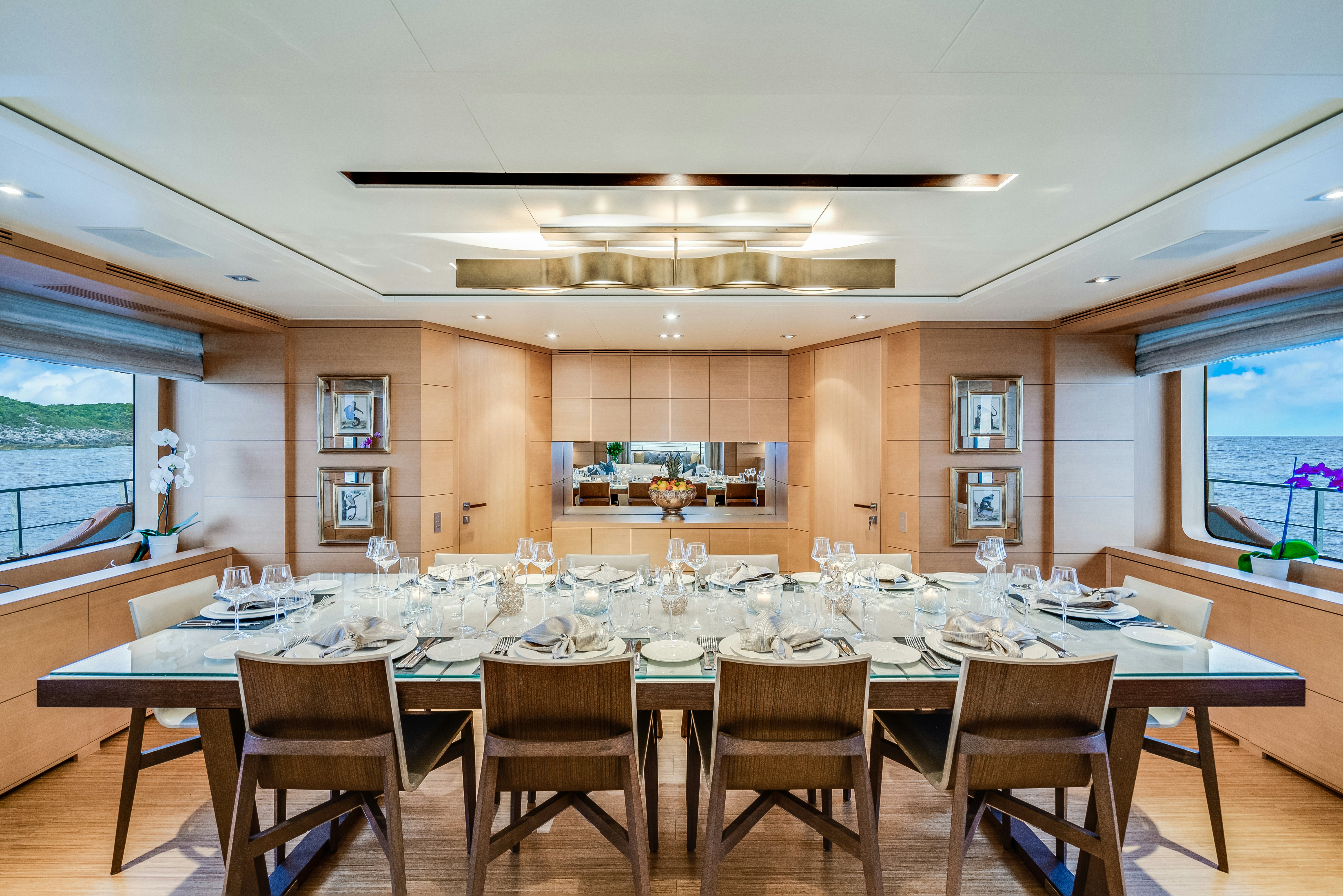 a large dining table in a room aboard LADY H Yacht for Charter