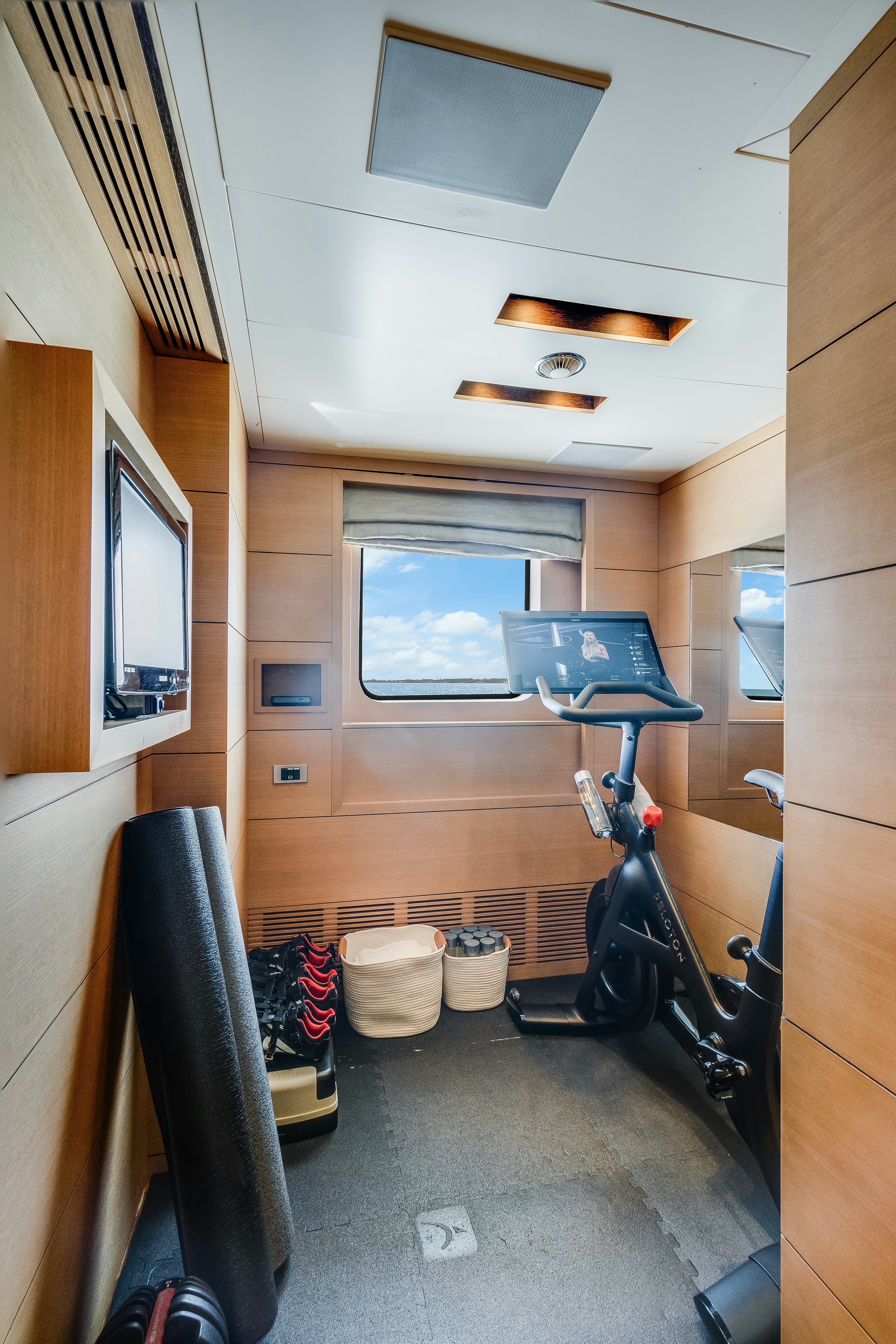a room with a bicycle and a television aboard LADY H Yacht for Charter