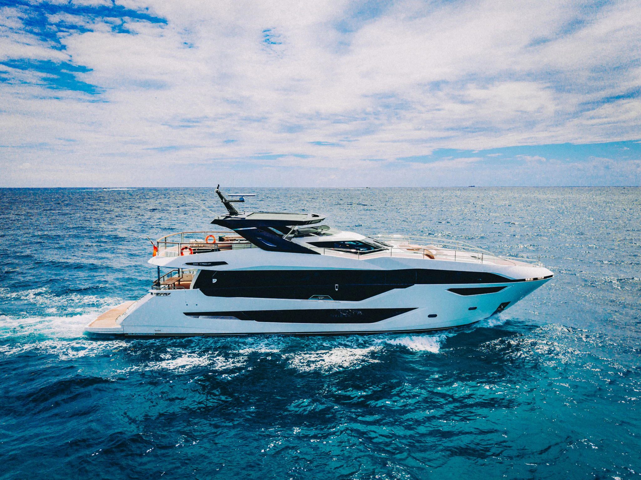 a white yacht in the water aboard PURA VIDA Yacht for Sale