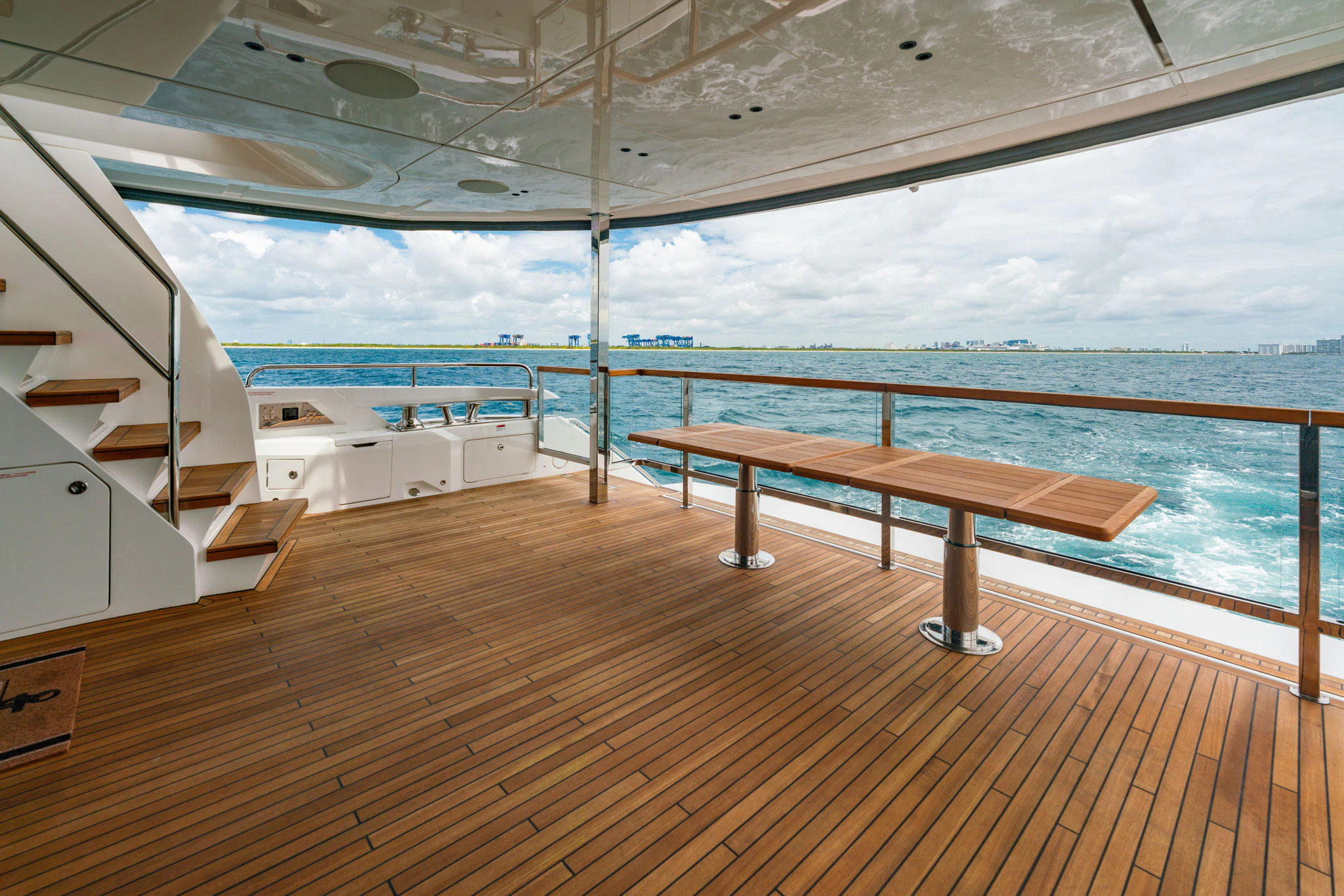 a wooden deck overlooking a body of water aboard PURA VIDA Yacht for Sale