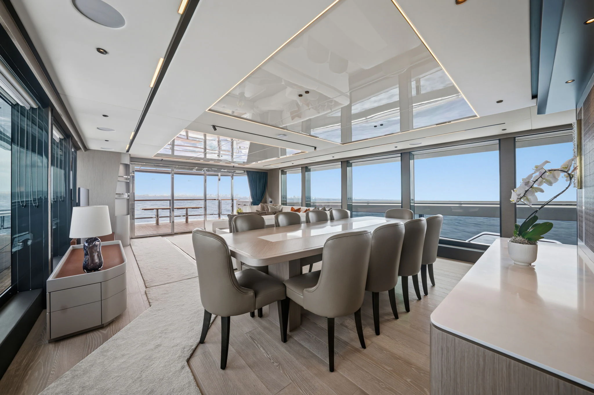 a room with tables and chairs aboard PURA VIDA Yacht for Sale