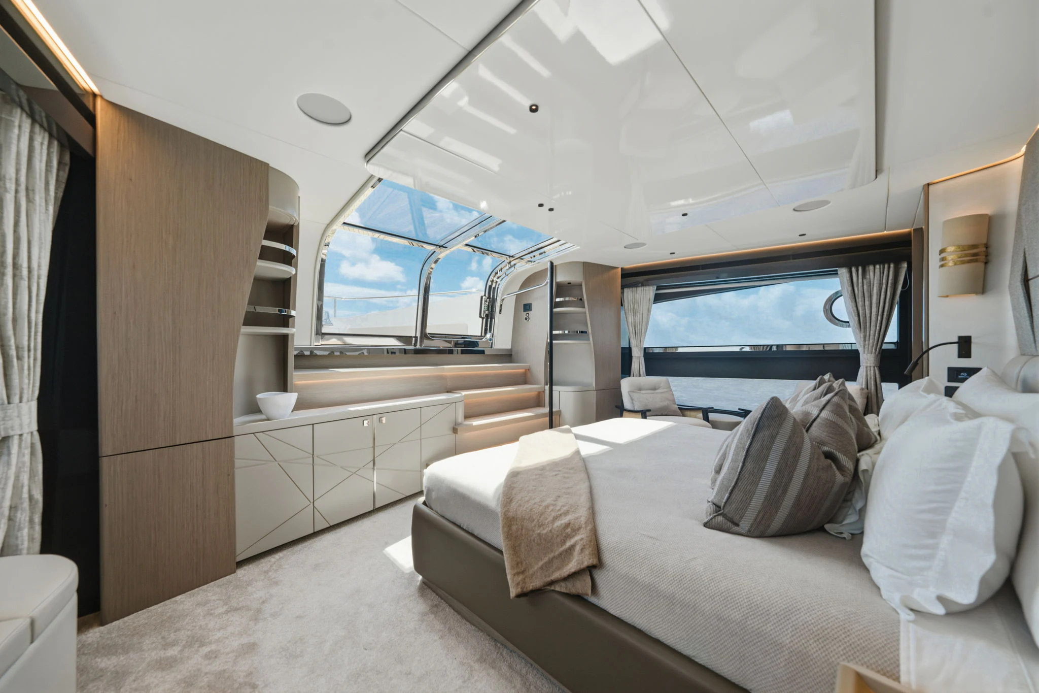 a bedroom with a bed and a television aboard PURA VIDA Yacht for Sale