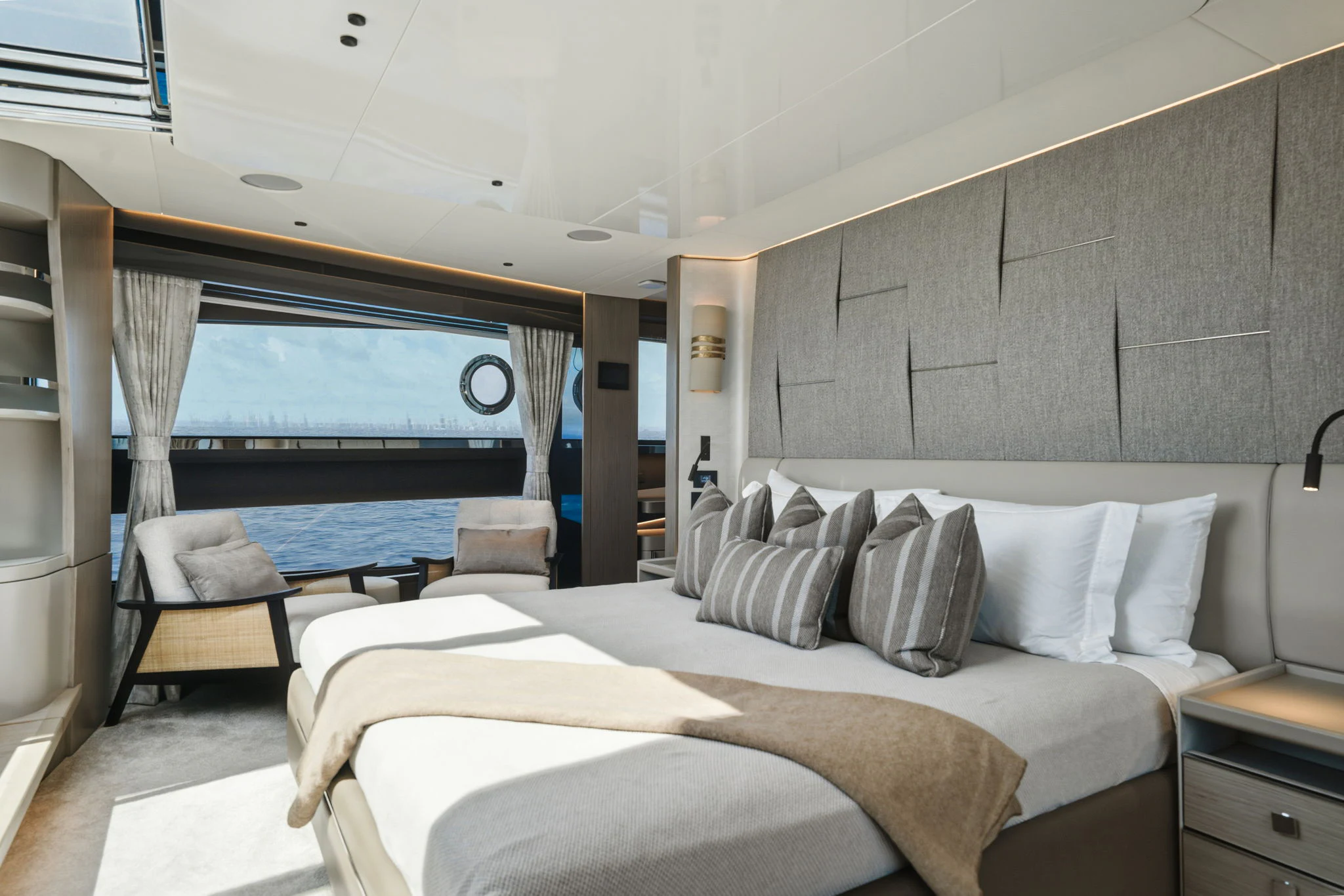 a room with a bed and a large window aboard PURA VIDA Yacht for Sale