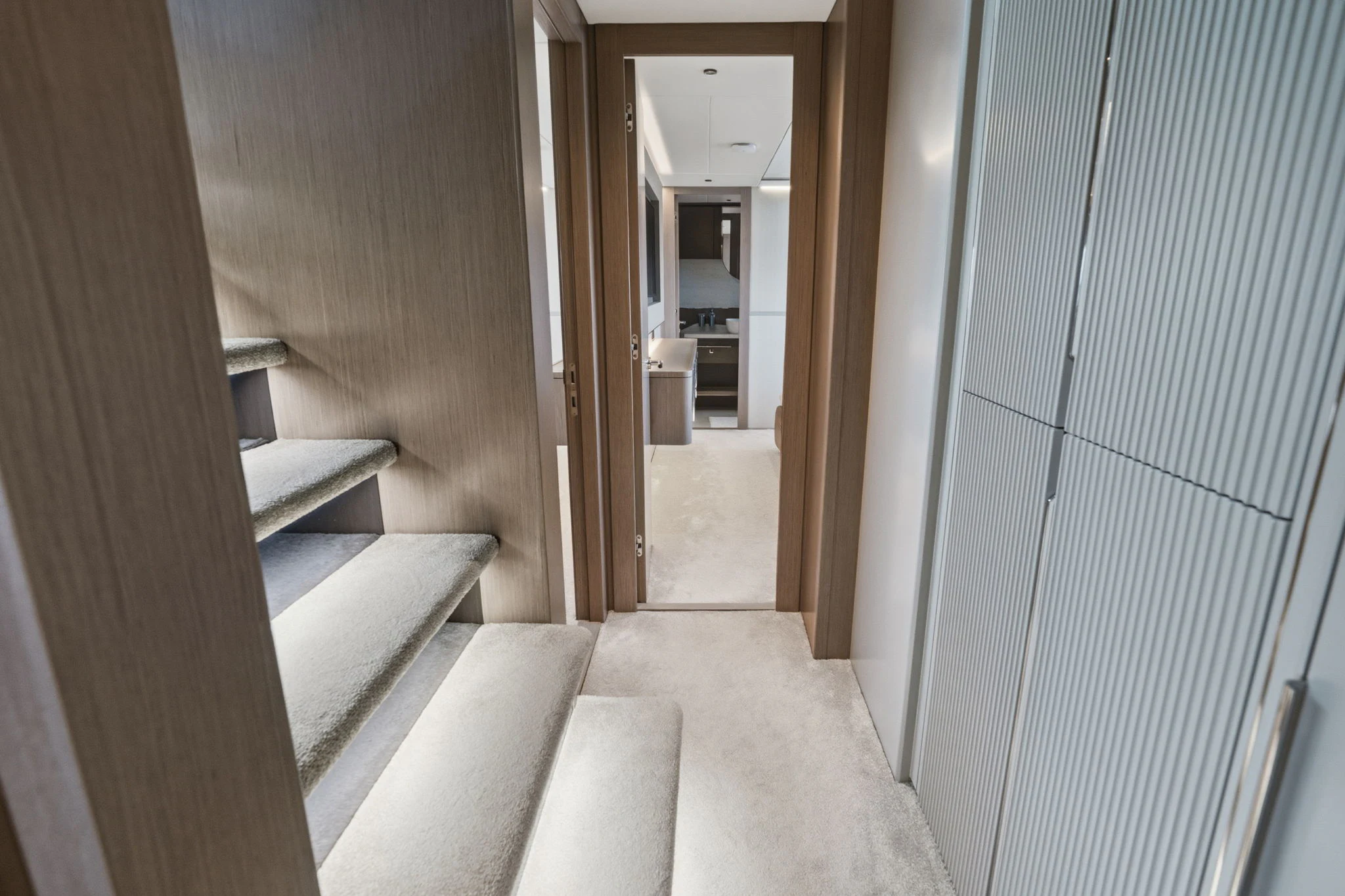 a hallway with a staircase and a door aboard PURA VIDA Yacht for Sale