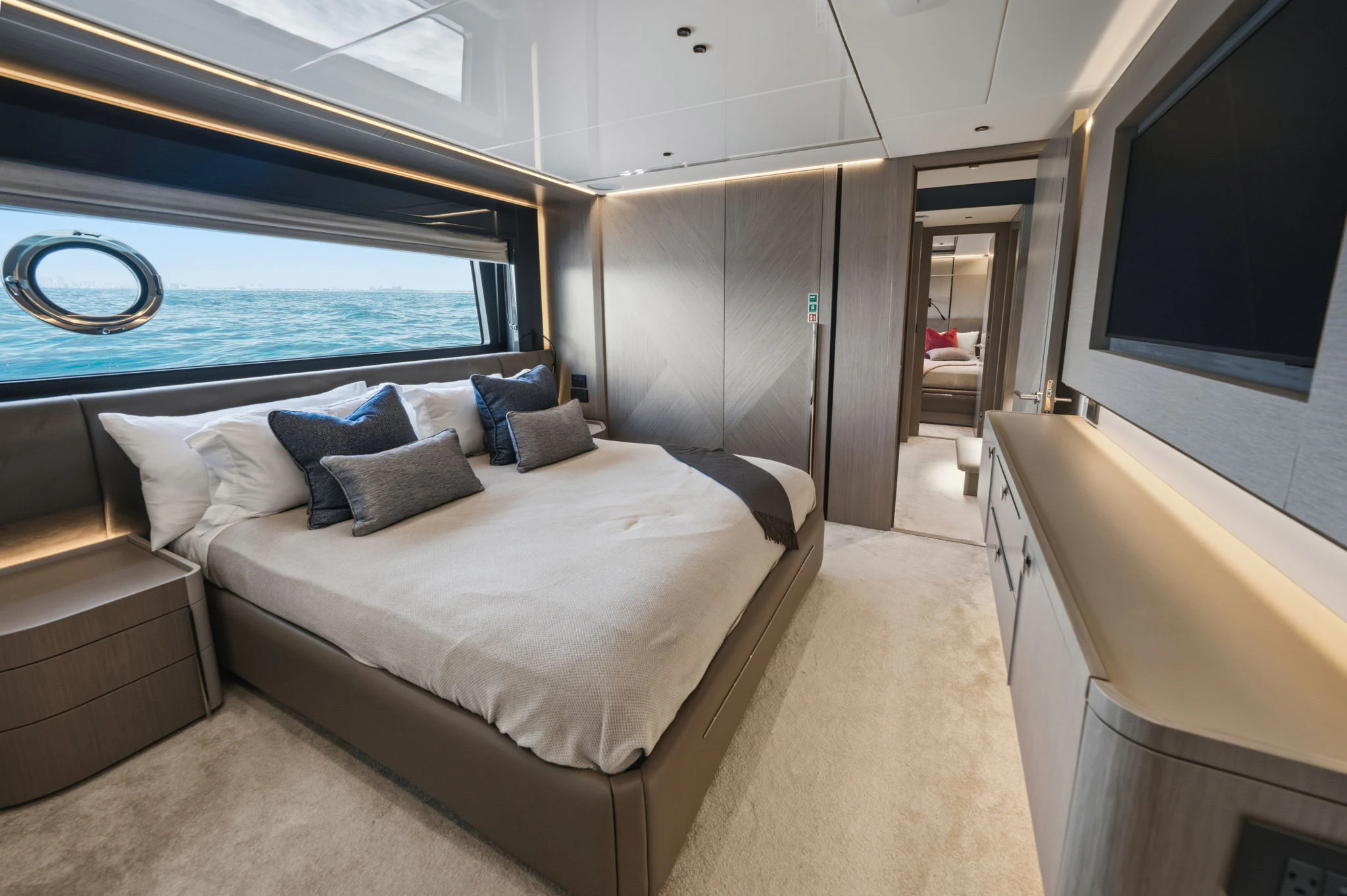 a room with a bed and a large window aboard PURA VIDA Yacht for Sale