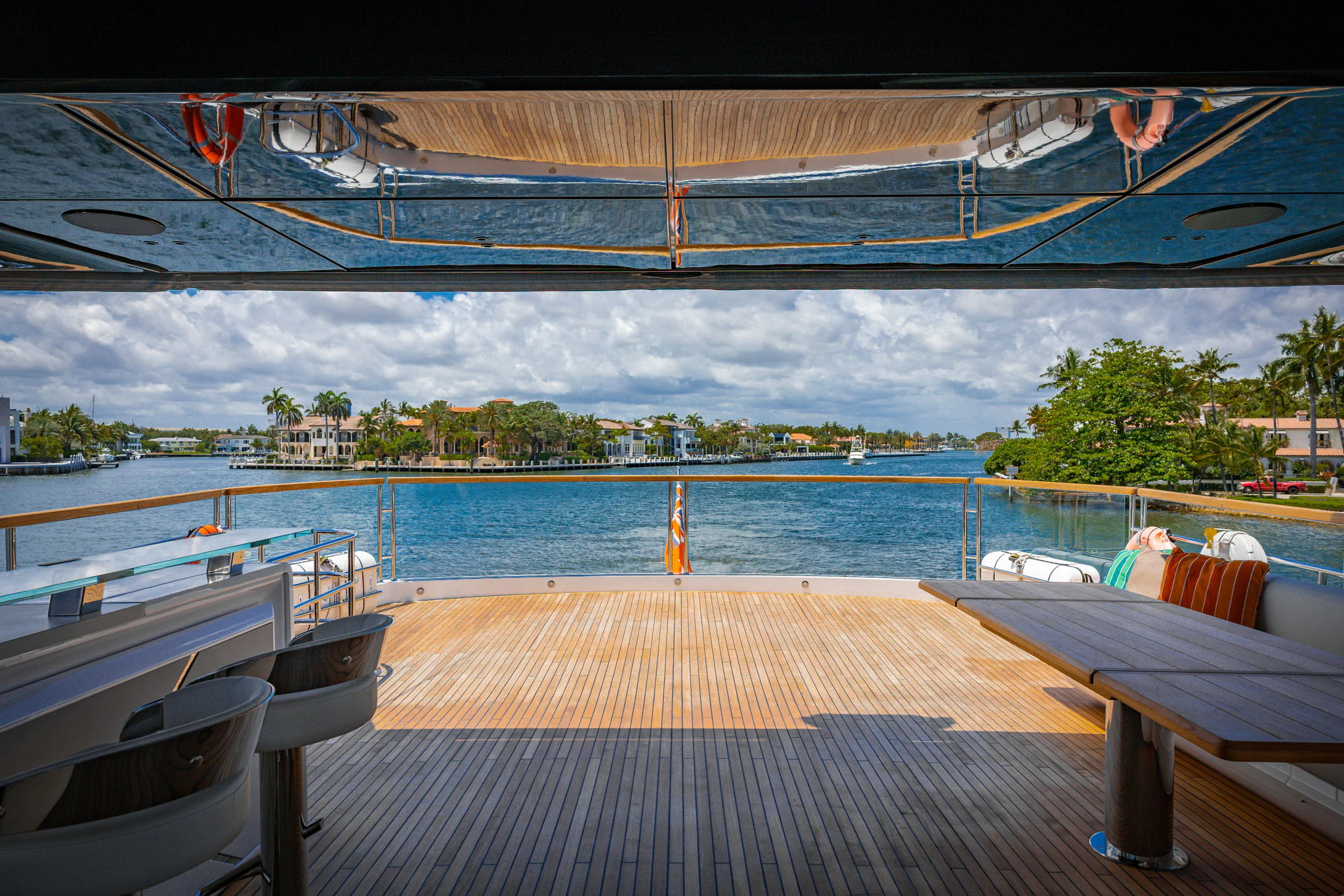 a deck with a view of a city and water aboard PURA VIDA Yacht for Sale