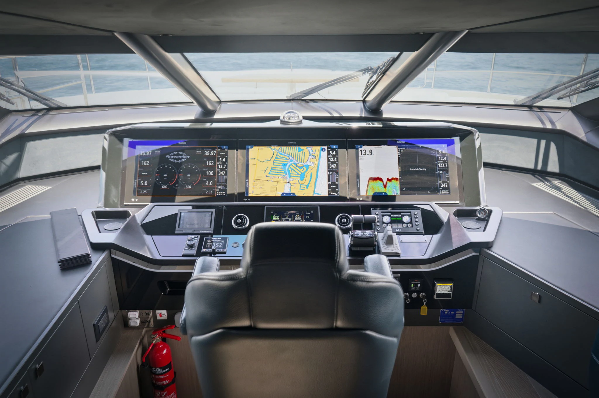 inside of a vehicle with a desk and chairs and a computer on the wall aboard PURA VIDA Yacht for Sale