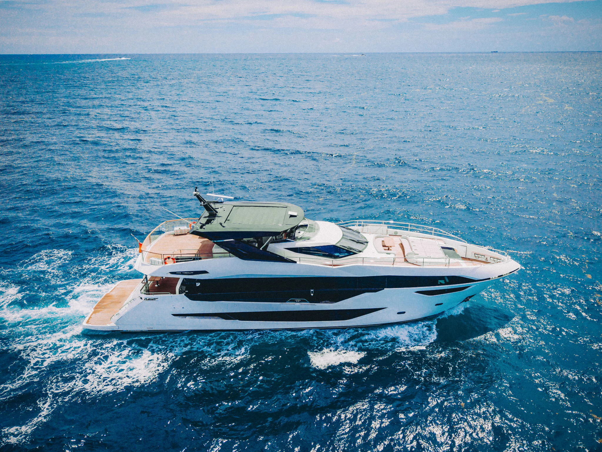 a white yacht in the water aboard PURA VIDA Yacht for Sale
