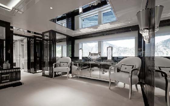 a room with a table chairs and a window aboard SILVER ANGEL Yacht for Charter