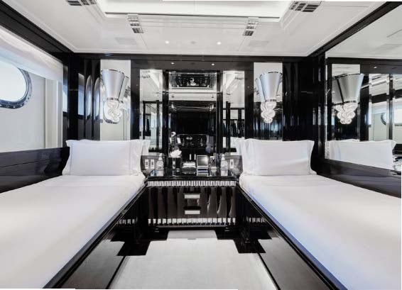 a room with beds and a table aboard SILVER ANGEL Yacht for Charter