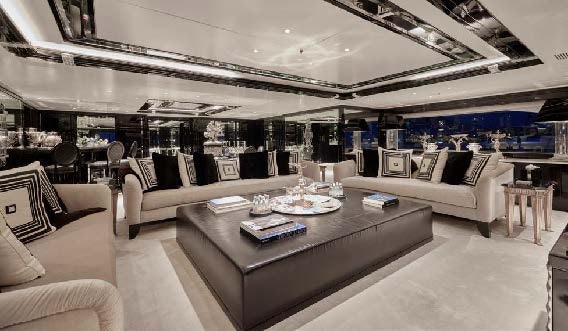 a living room with a large white sofa and a large table aboard SILVER ANGEL Yacht for Charter