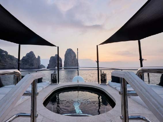a deck with a view of a city and water aboard SILVER ANGEL Yacht for Charter