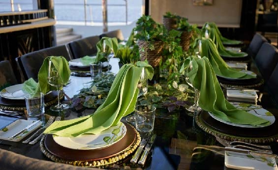 a table with plates and glasses aboard SILVER ANGEL Yacht for Charter