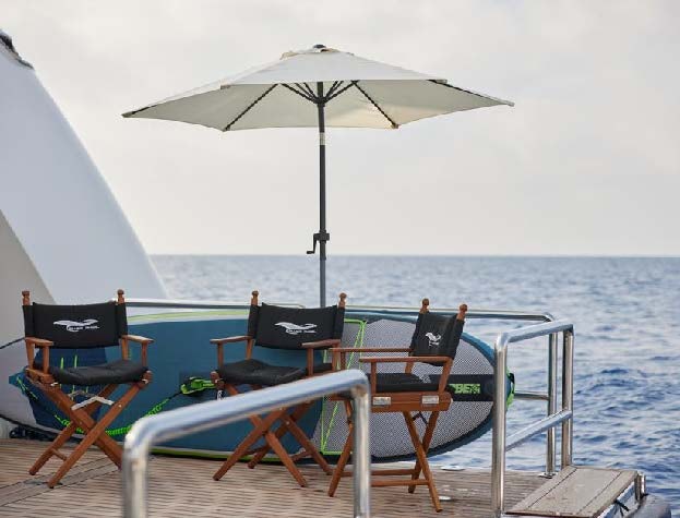 a couple of chairs and an umbrella on a boat aboard SILVER ANGEL Yacht for Charter