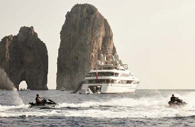 a boat in the water with Haystack Rock in the background aboard SILVER ANGEL Yacht for Charter