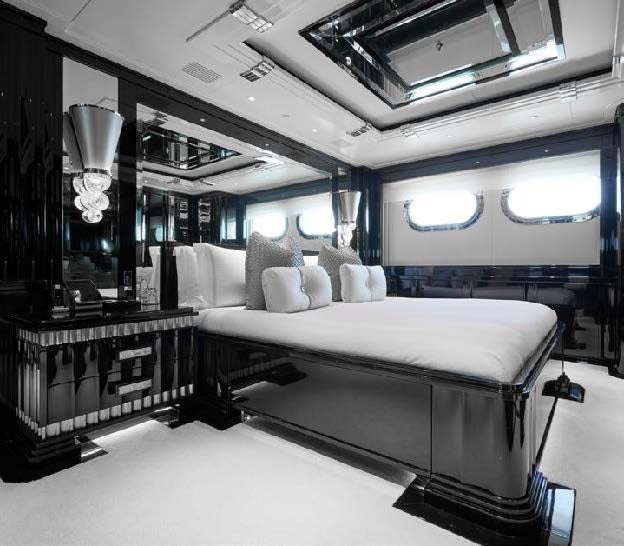 a room with a bed and a mirror aboard SILVER ANGEL Yacht for Charter