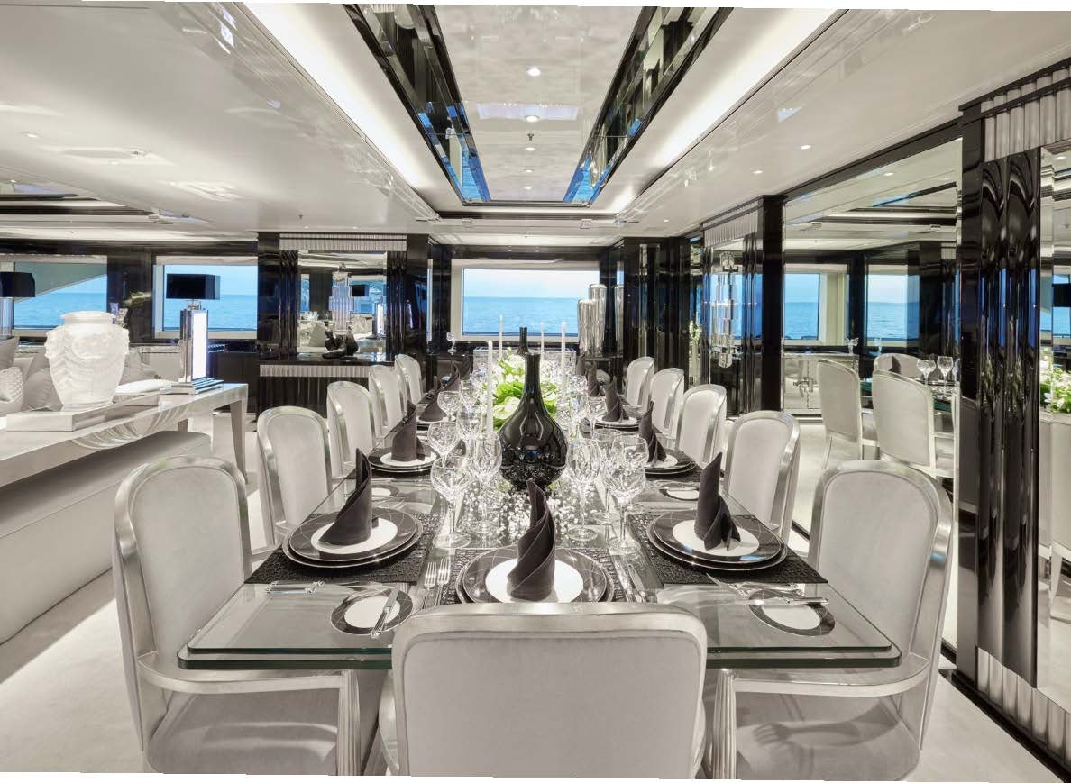 a room with tables and chairs aboard SILVER ANGEL Yacht for Charter