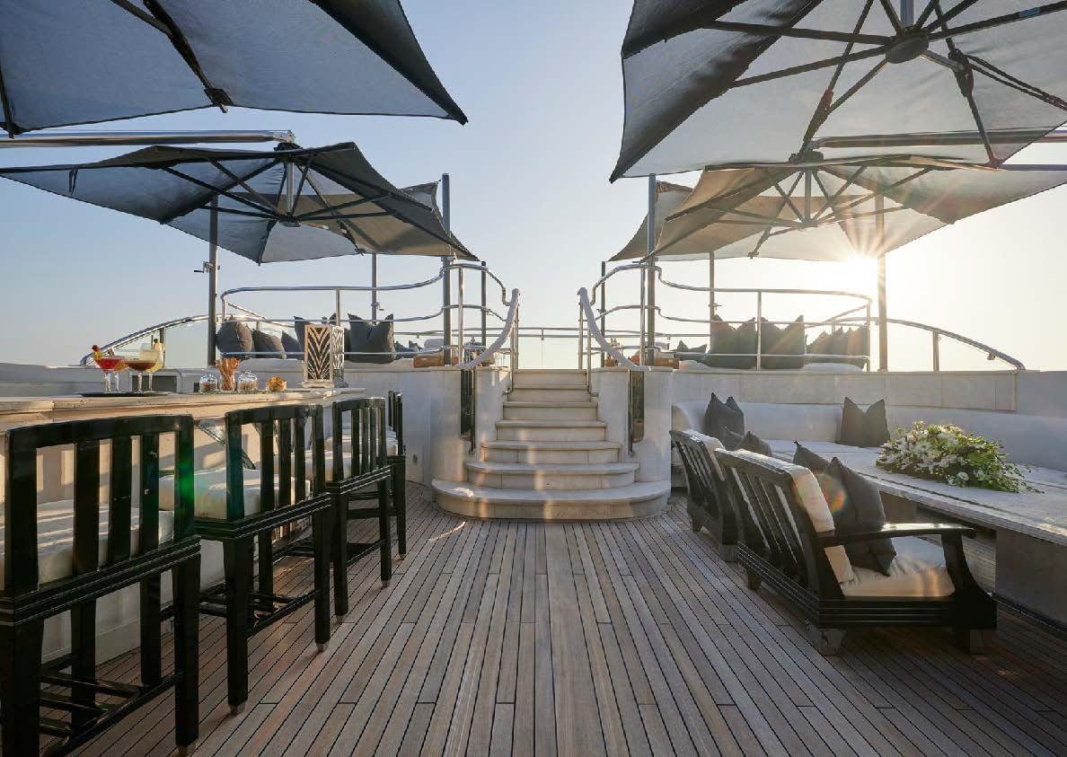 a patio with a table and chairs aboard SILVER ANGEL Yacht for Charter