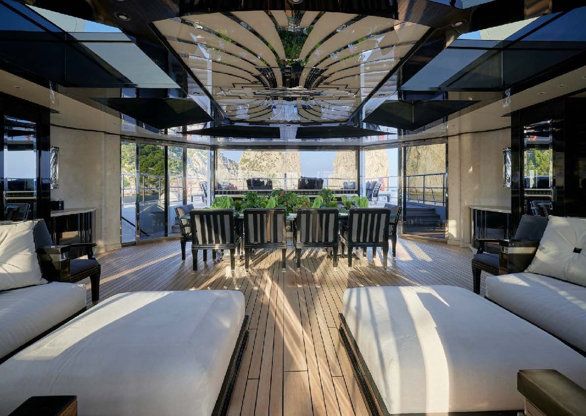 a room with a table chairs and a large window aboard SILVER ANGEL Yacht for Charter