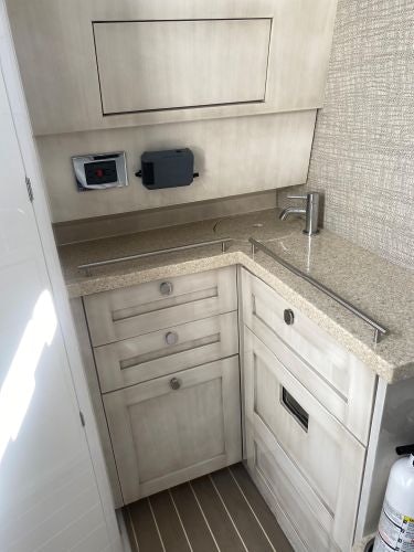 a kitchen with a microwave and cabinets aboard RELAPSE Yacht for Sale