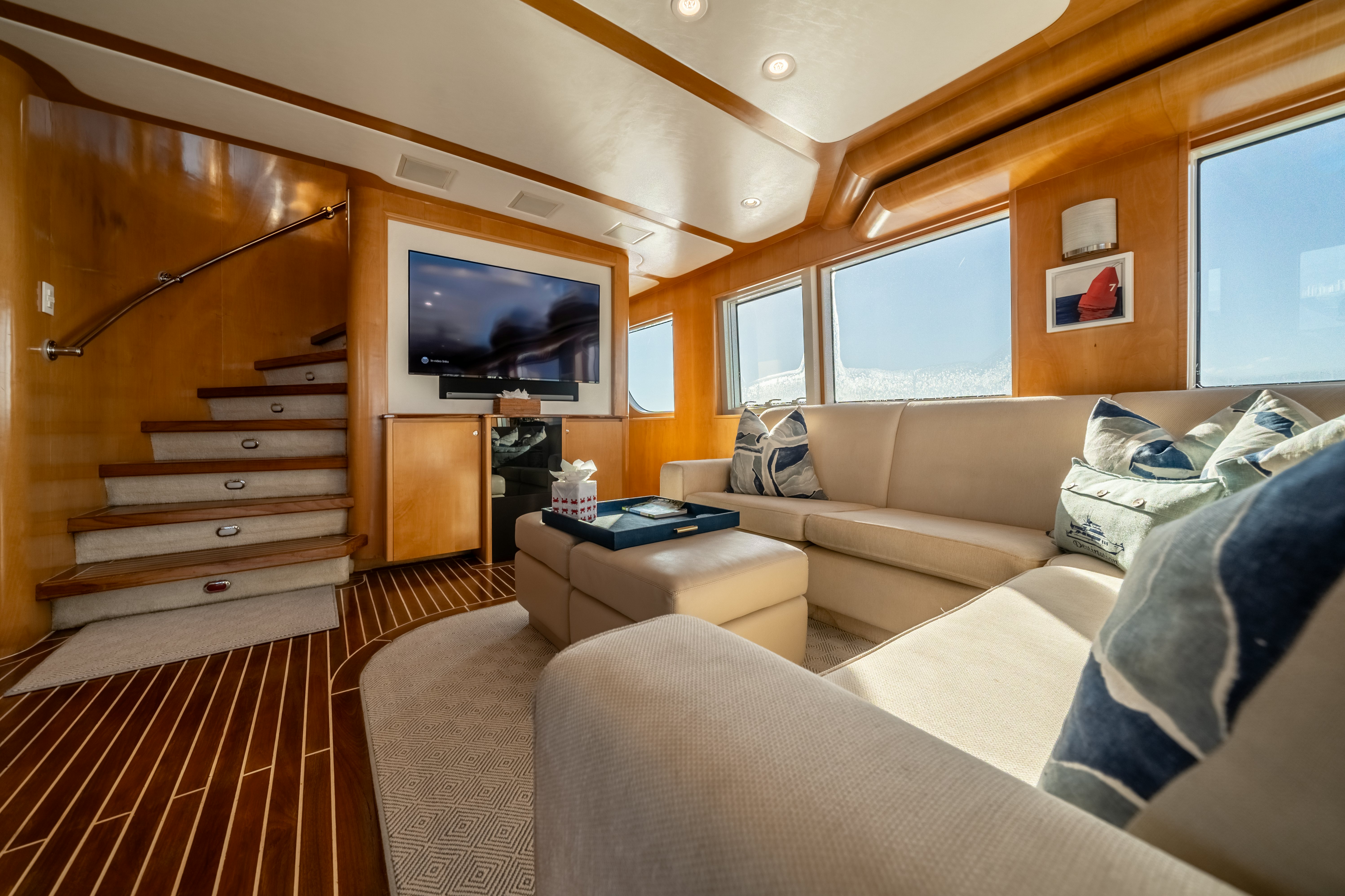 a living room with a wood staircase aboard DESTINATION Yacht for Sale