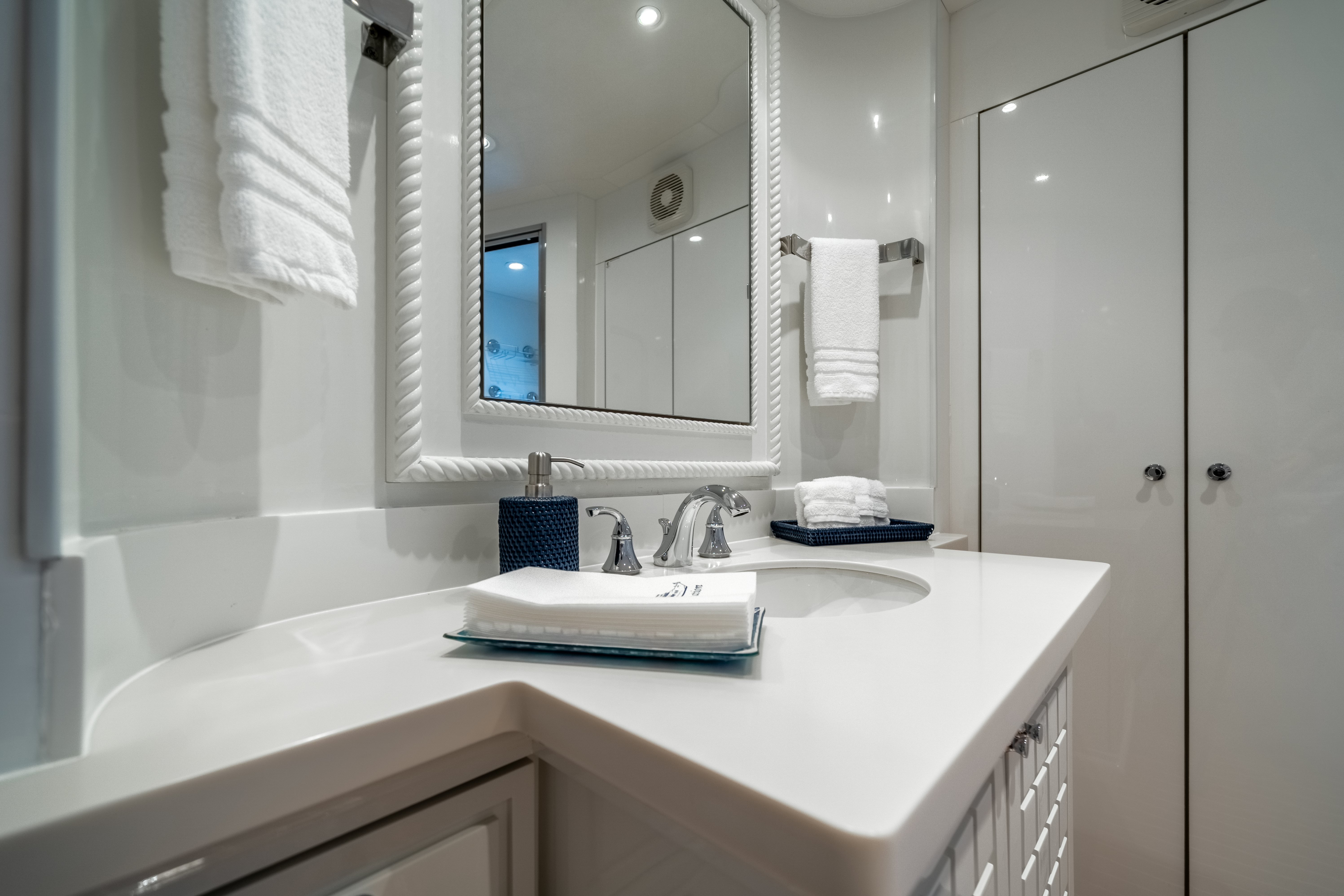 a bathroom with a sink and a mirror aboard DESTINATION Yacht for Sale