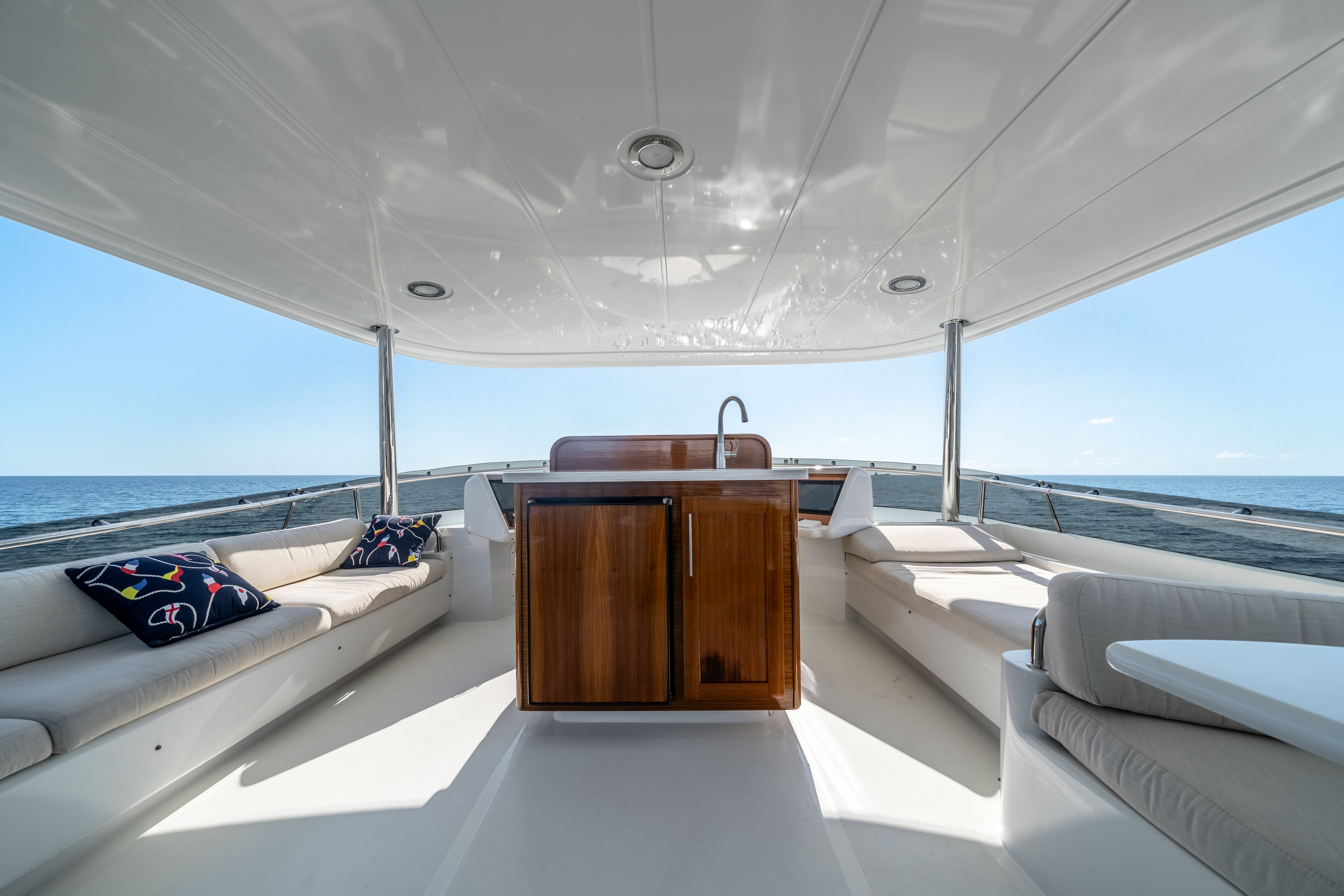a room with a bed and a wood cabinet aboard DESTINATION Yacht for Sale