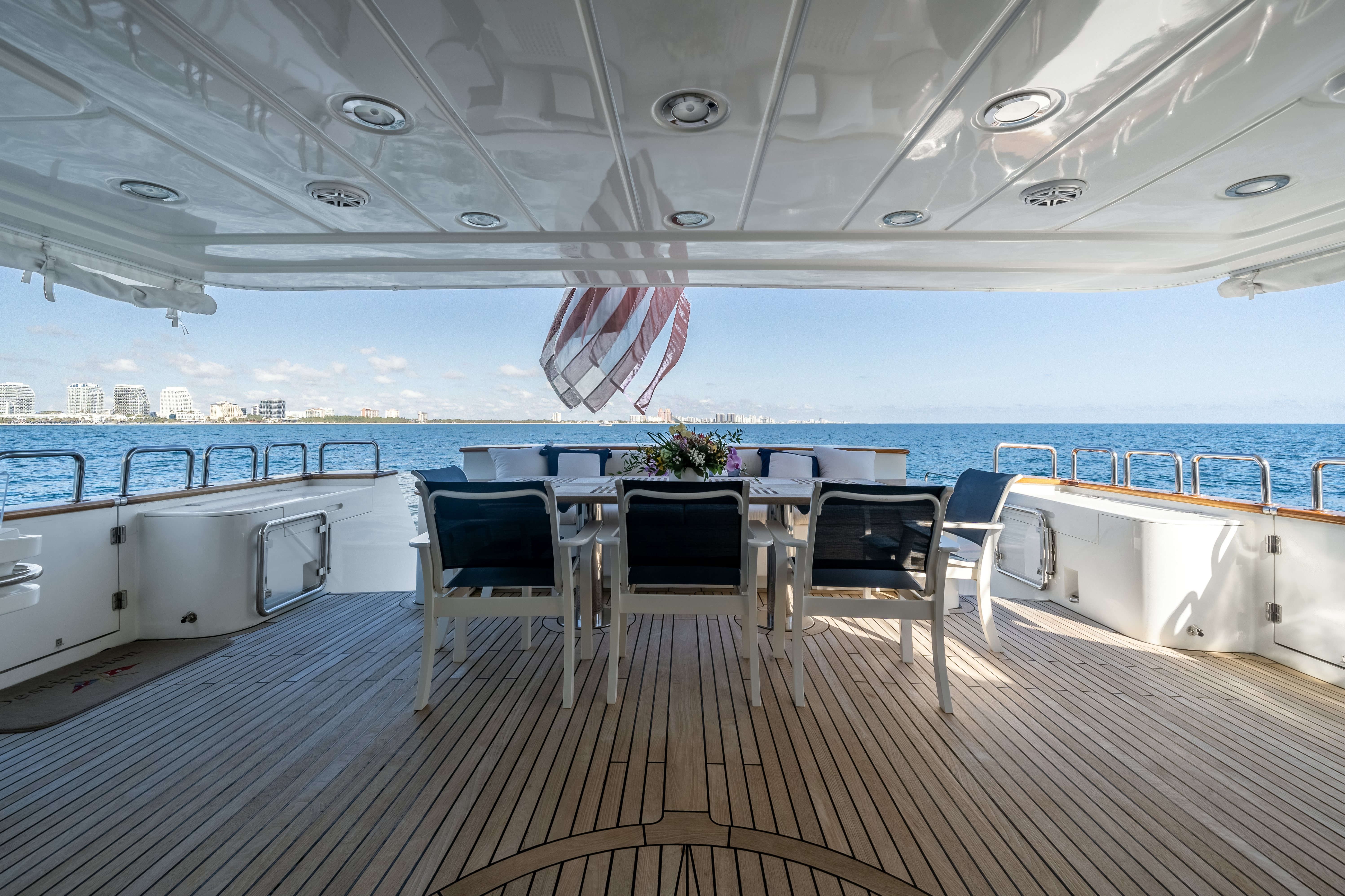 a deck with chairs and tables on it aboard DESTINATION Yacht for Sale