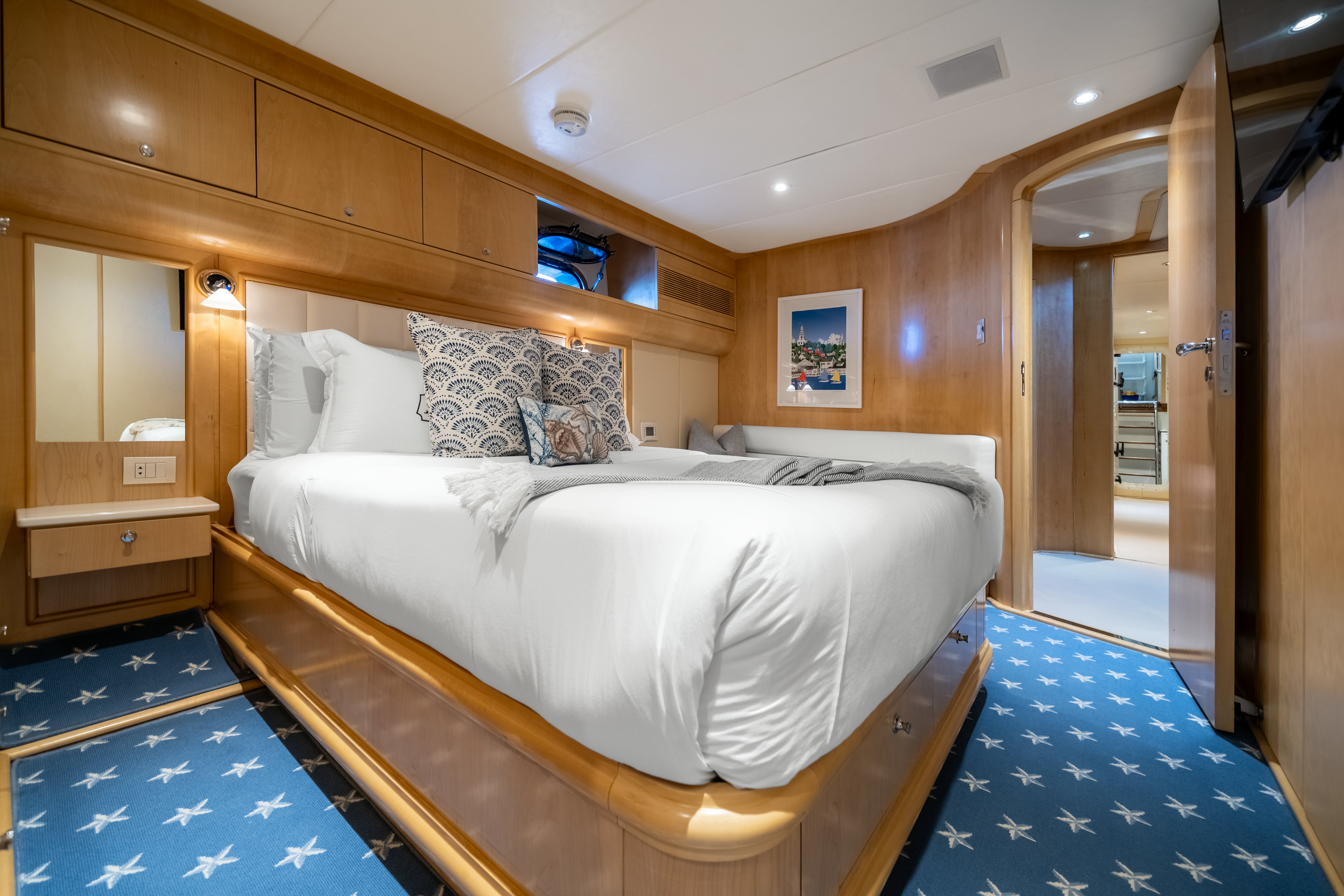 a room with a bed and a blue rug aboard DESTINATION Yacht for Sale