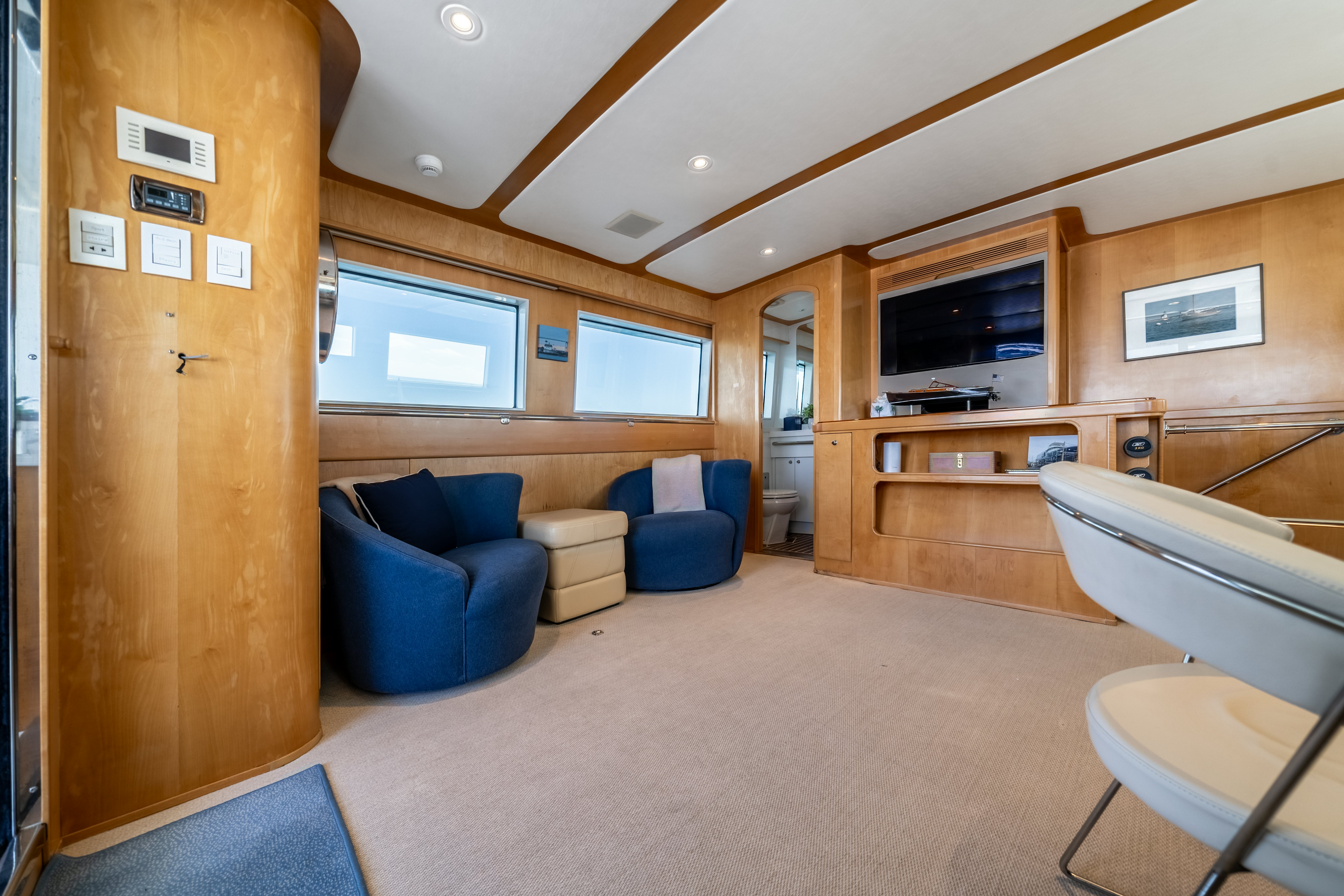 a living room with a couch and a television aboard DESTINATION Yacht for Sale