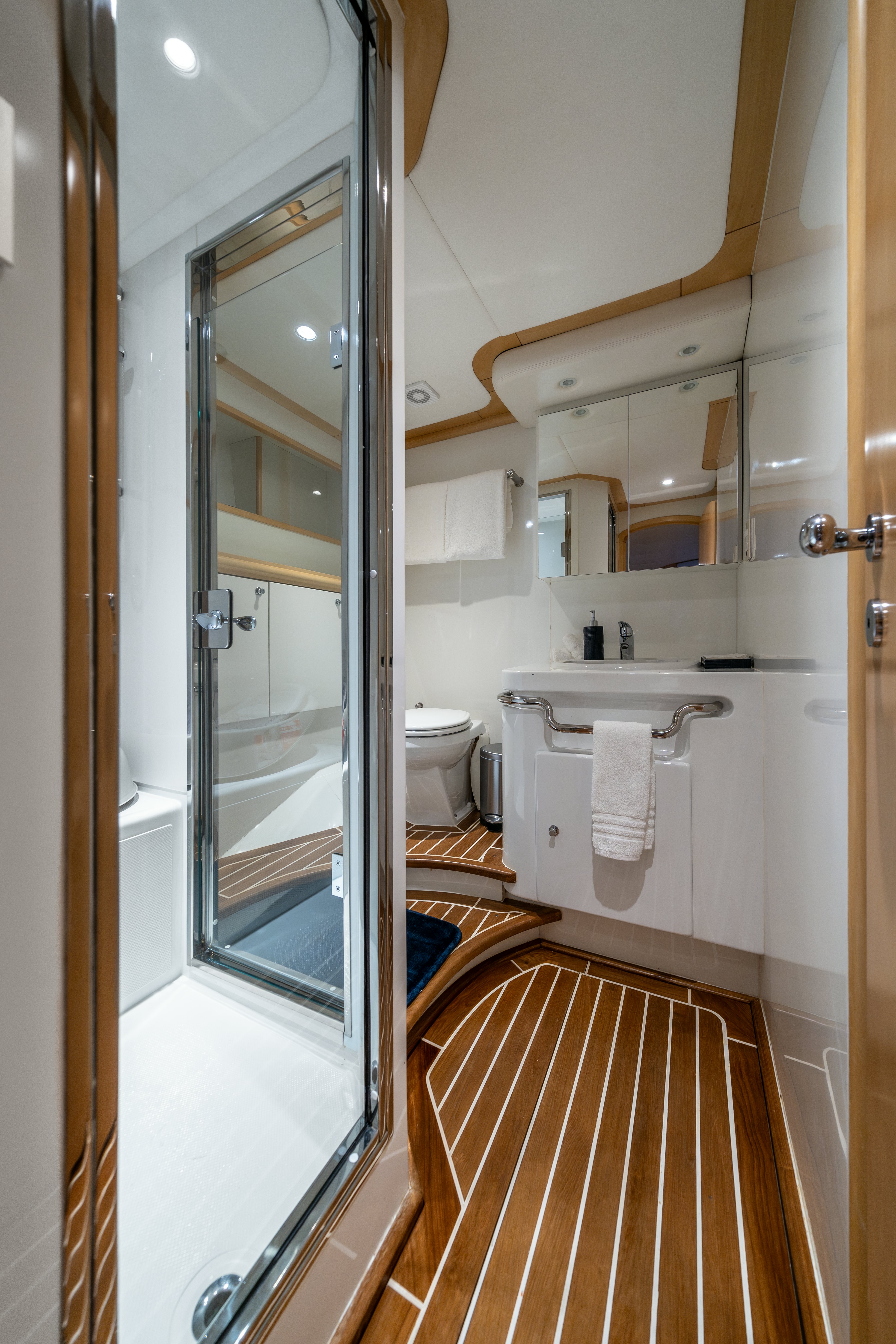 a bathroom with a glass shower aboard DESTINATION Yacht for Sale