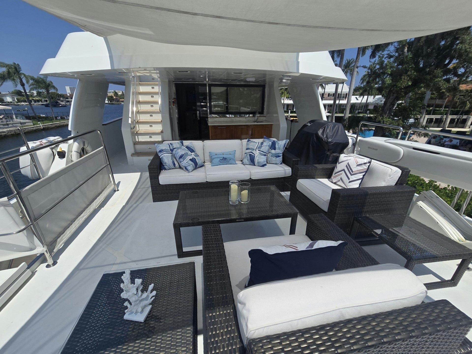 a patio with a couch and a table on it aboard DESTINATION Yacht for Sale