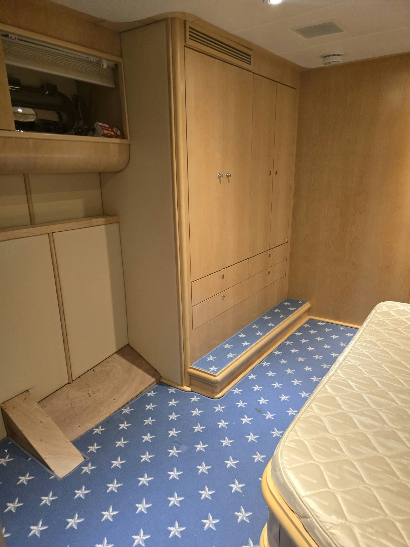 a room with a bed and a desk aboard DESTINATION Yacht for Sale