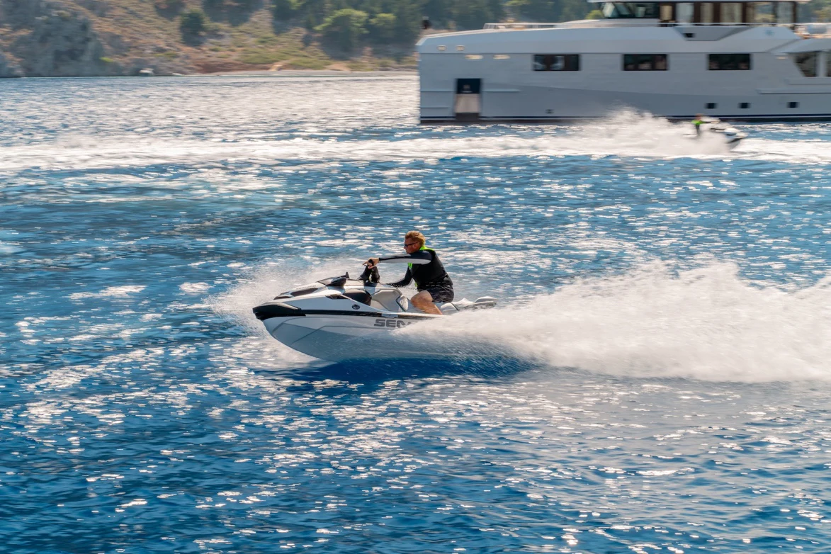 a couple of people on a jet ski in the water aboard AFTER YOU Yacht for Charter