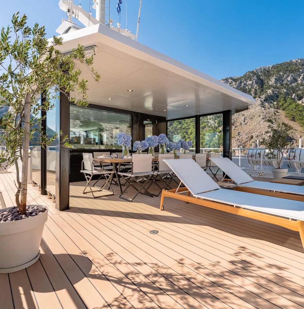 a patio with tables and chairs aboard AFTER YOU Yacht for Charter
