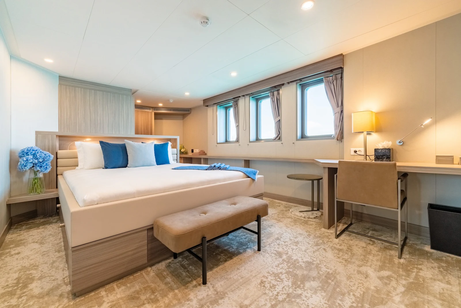 a bedroom with a bed and desk aboard AFTER YOU Yacht for Charter