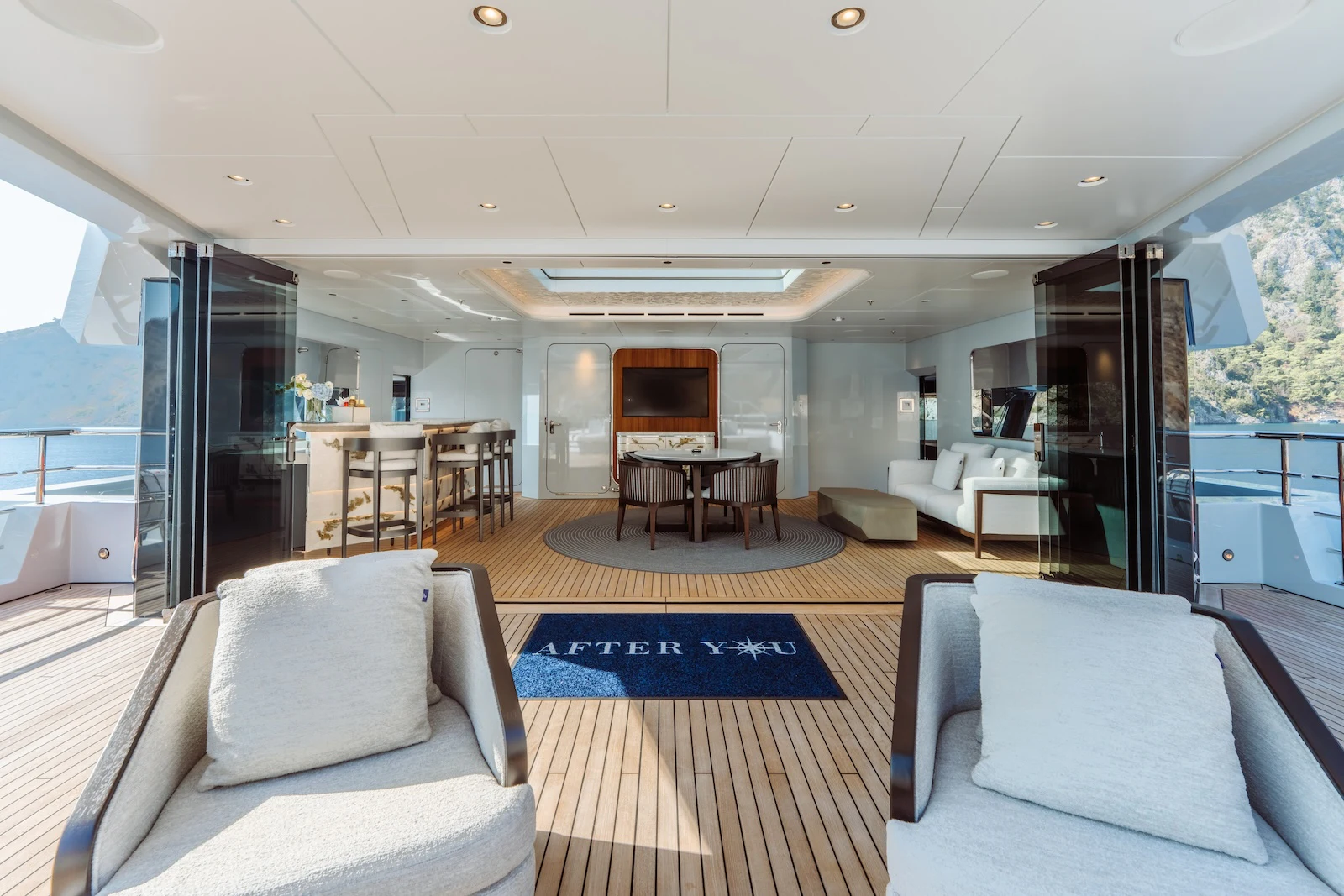 a living room with a wood floor aboard AFTER YOU Yacht for Charter