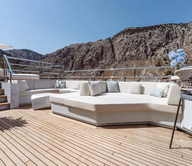 a large white couch on a deck aboard AFTER YOU Yacht for Charter