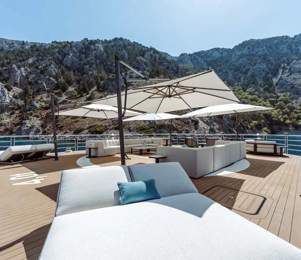 a lounge area with a large umbrella aboard AFTER YOU Yacht for Charter